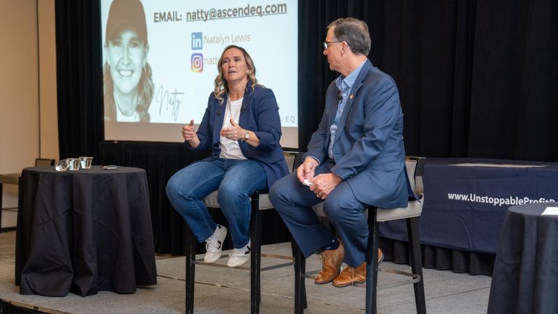 Natty Lewis speaking with someone